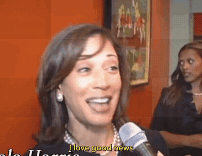 A Woman Talking Into A Microphone With The Words I Love Good News Written Below Her GIF