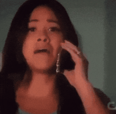 A Woman Talking On A Cell Phone With A Blurred Background GIF
