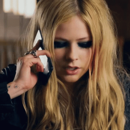 A Woman Talking On A Cell Phone With A Ring On Her Finger GIF