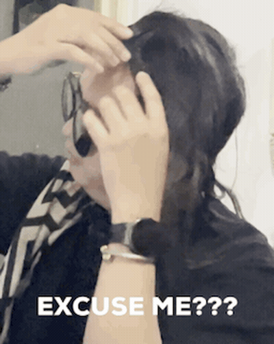A Woman Talking On A Cell Phone With The Words " Excuse Me " On The Bottom GIF