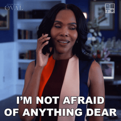 A Woman Talking On A Cell Phone With The Words I 'M Not Afraid Of Anything Dear Below Her GIF