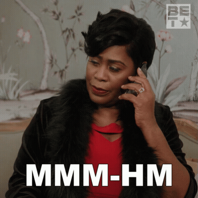 A Woman Talking On A Cell Phone With The Words " Mmmm-Hm " Below Her GIF