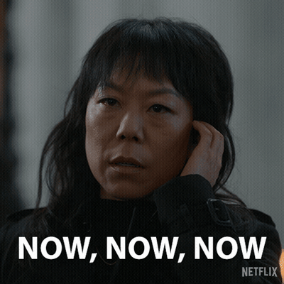 A Woman Talking On A Cell Phone With The Words Now Now Now Written On The Bottom GIF