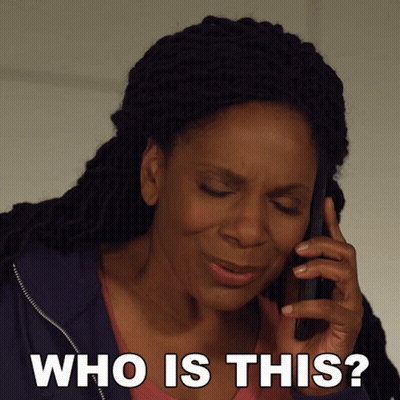 A Woman Talking On A Cell Phone With The Words " Who Is This " Below Her GIF