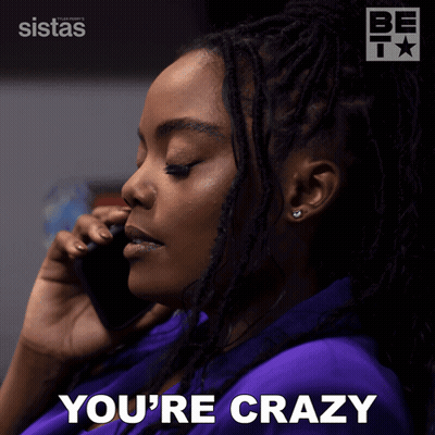 A Woman Talking On A Cell Phone With The Words You 'Re Crazy Behind Her GIF