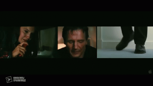 A Woman Talking On A Phone Next To A Man In A Dark Room GIF