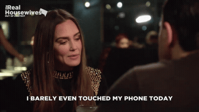A Woman Talking To A Man With The Words " I Barely Even Touched My Phone Today " GIF