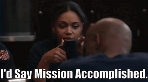 A Woman Talking To A Man With The Words " I 'D Say Mission Accomplished " On The Bottom GIF