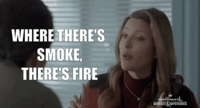 A Woman Talking To A Man With The Words " Where There 'S Smoke There 'S Fire " Above Her GIF