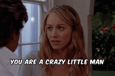 A Woman Talking To A Man With The Words You Are A Crazy Little Man Below Her GIF