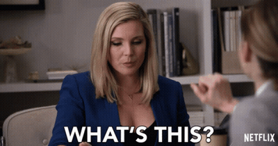 A Woman Talking To Another Woman With The Words " What 'S This " On The Bottom GIF