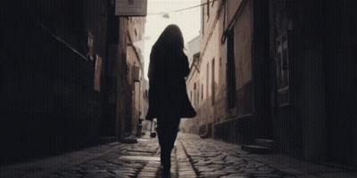 A Woman Walking Down A Cobblestone Street With A Sign That Says ' A Few Steps ' On It GIF