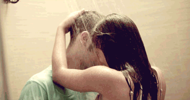 A Woman Washing A Man 'S Hair In A Shower GIF