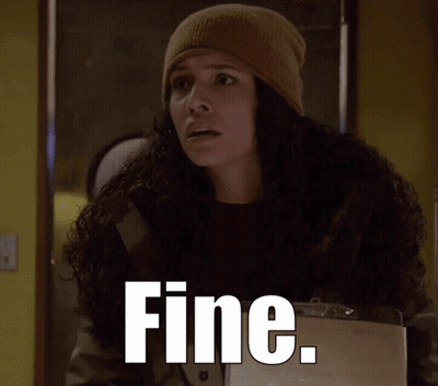 A Woman Wearing A Beanie And A Jacket With The Word Fine Written On It GIF