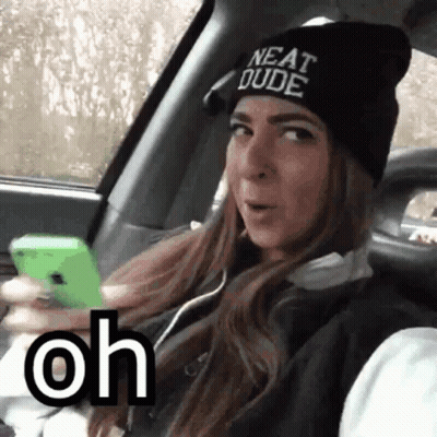 A Woman Wearing A Beanie That Says Neat Dude Is Sitting In A Car GIF