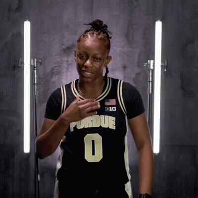 A Woman Wearing A Black And Gold Purdue Jersey Number 0 GIF