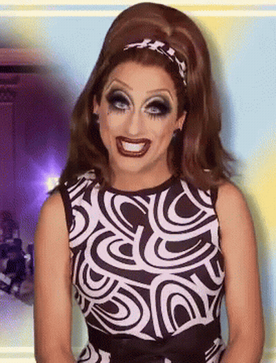 A Woman Wearing A Black And White Dress With A Swirl Pattern GIF