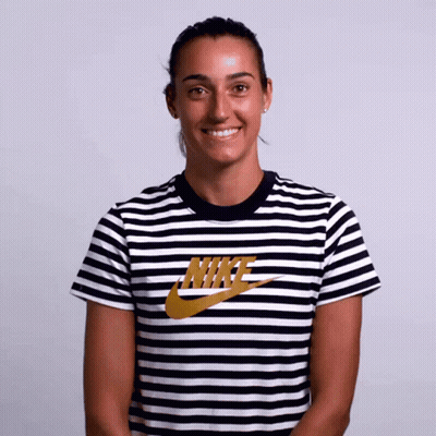 A Woman Wearing A Black And White Nike Striped Shirt GIF