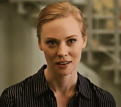 A Woman Wearing A Black And White Striped Shirt Smiles GIF