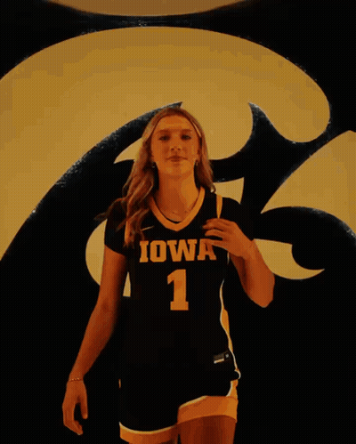 A Woman Wearing A Black And Yellow Jersey With Iowa 1 On It GIF