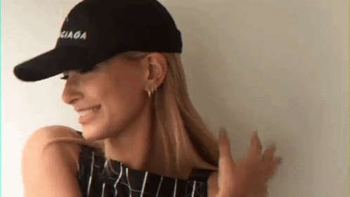 A Woman Wearing A Black Balenciaga Baseball Cap GIF