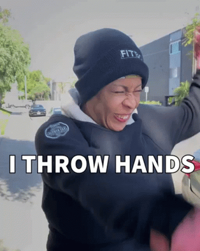A Woman Wearing A Black Beanie And A Black Jacket Says " I Throw Hands " GIF