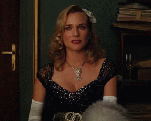 A Woman Wearing A Black Dress And White Gloves Has A Necklace On GIF