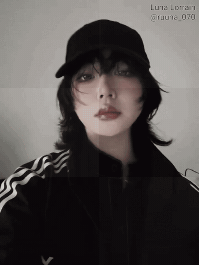 A Woman Wearing A Black Hat And A Black Jacket Has The Name Luna Lorain Written Above Her GIF