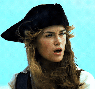 A Woman Wearing A Black Hat Looks At The Camera GIF