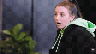 A Woman Wearing A Black Hoodie And A Green Hoodie That Says Alo GIF