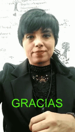 A Woman Wearing A Black Jacket And A Black Top With The Word Gracias On It GIF