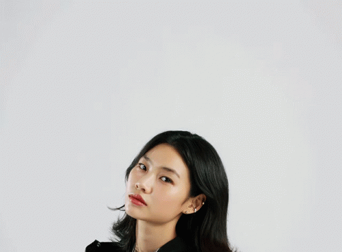 A Woman Wearing A Black Jacket With The Word Adidas On The Front GIF