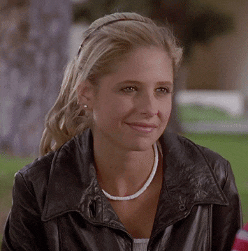 Woman Smiling In Leather Jacket And Necklace GIF