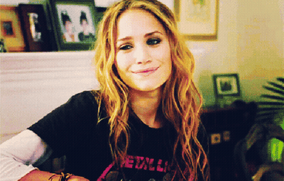 A Woman Wearing A Black Metallica Shirt Smiles GIF