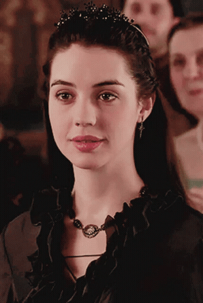 A Woman Wearing A Black Necklace And A Tiara GIF