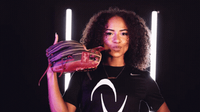 A Woman Wearing A Black Nike Shirt Is Holding A Red Baseball Glove GIF