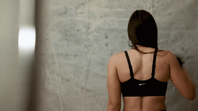 A Woman Wearing A Black Nike Sports Bra GIF