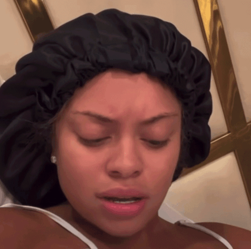 A Woman Wearing A Black Satin Bonnet Makes A Funny Face GIF