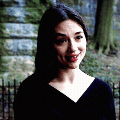 A Woman Wearing A Black Shirt And Red Lipstick Is Smiling GIF