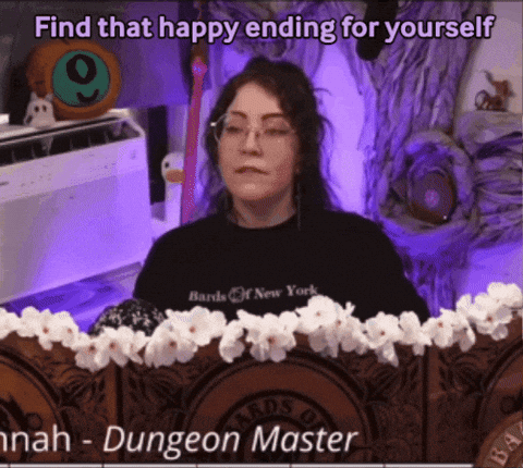 A Woman Wearing A Black Shirt That Says Bards Of New York Sits At A Table GIF
