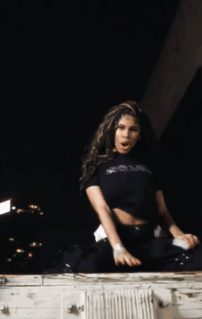 A Woman Wearing A Black Shirt That Says Just Be Jealous Smoking A Cigarette GIF