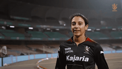 A Woman Wearing A Black Shirt That Says Kajaria On It GIF