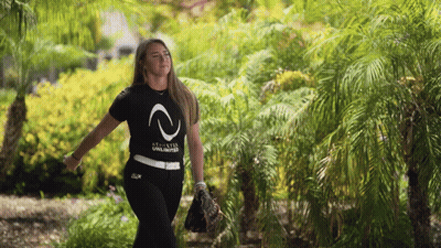 A Woman Wearing A Black Shirt That Says " Stixstar Unlimited " GIF