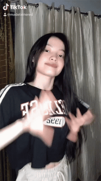 A Woman Wearing A Black Shirt That Says Texas GIF