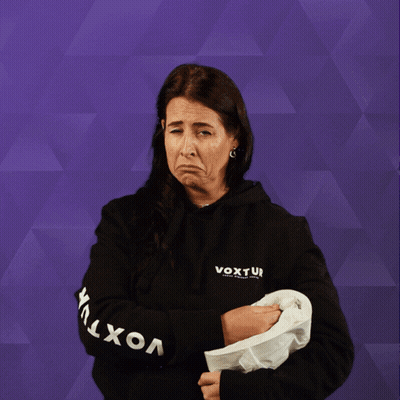 A Woman Wearing A Black Shirt That Says ' Ui ' On It Holds Up A Roll Of Toilet Paper GIF