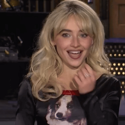 A Woman Wearing A Black Shirt With A Dog On It GIF