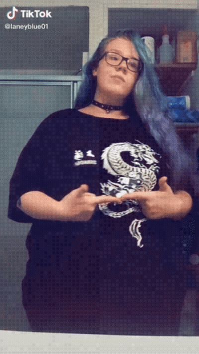 A Woman Wearing A Black Shirt With A Dragon On It GIF