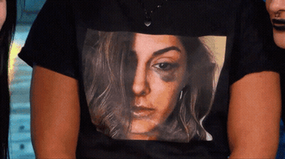 A Woman Wearing A Black Shirt With A Picture Of A Woman With A Black Eye GIF