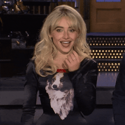 A Woman Wearing A Black Sweater With A Dog On It GIF