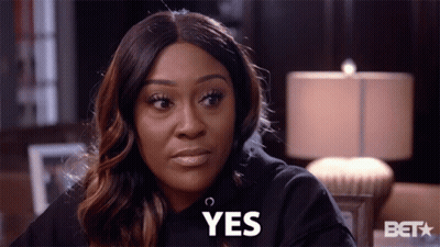 A Woman Wearing A Black Sweatshirt Says Yes GIF